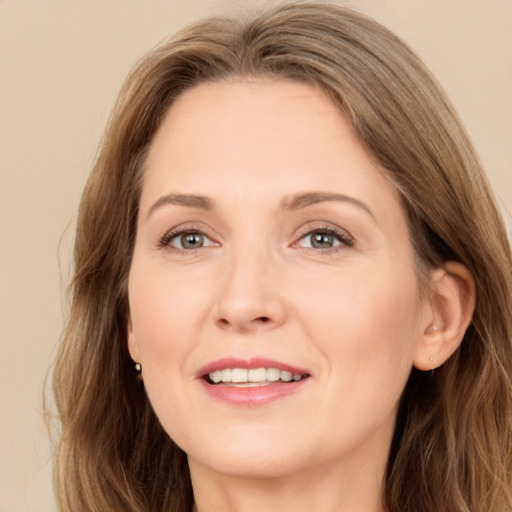 Joyful white adult female with long  brown hair and brown eyes