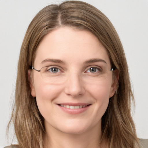 Joyful white young-adult female with long  brown hair and grey eyes