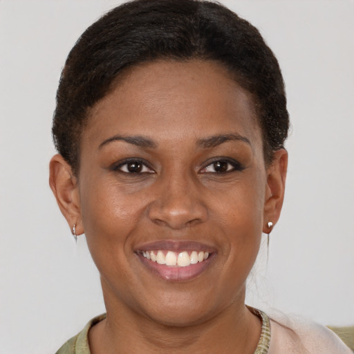 Joyful black young-adult female with short  brown hair and brown eyes