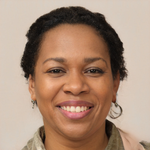 Joyful black adult female with short  brown hair and brown eyes