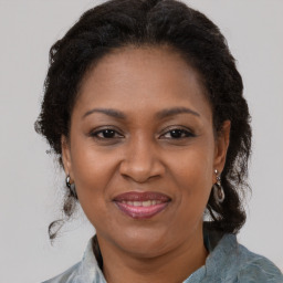 Joyful black adult female with medium  brown hair and brown eyes