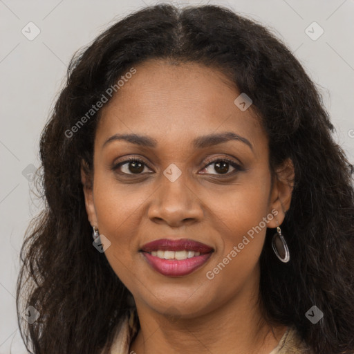 Joyful black young-adult female with long  brown hair and brown eyes