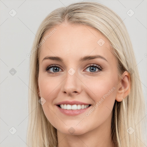 Joyful white young-adult female with long  brown hair and blue eyes