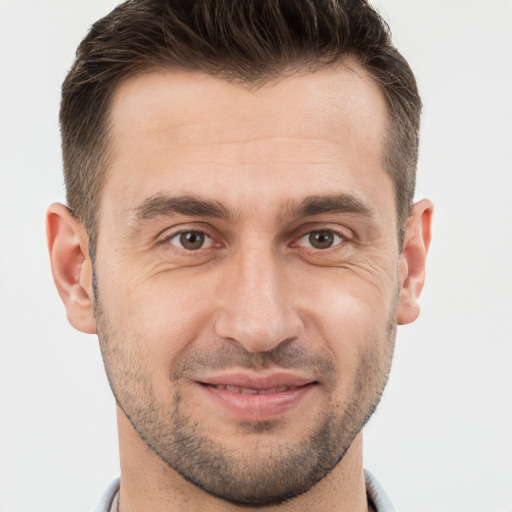 Joyful white adult male with short  brown hair and brown eyes