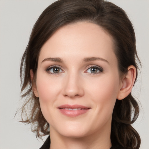 Joyful white young-adult female with medium  brown hair and grey eyes