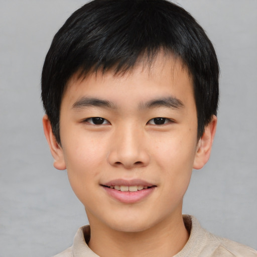 Joyful asian child male with short  black hair and brown eyes