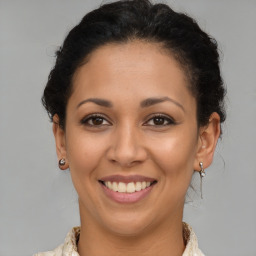 Joyful latino young-adult female with medium  brown hair and brown eyes