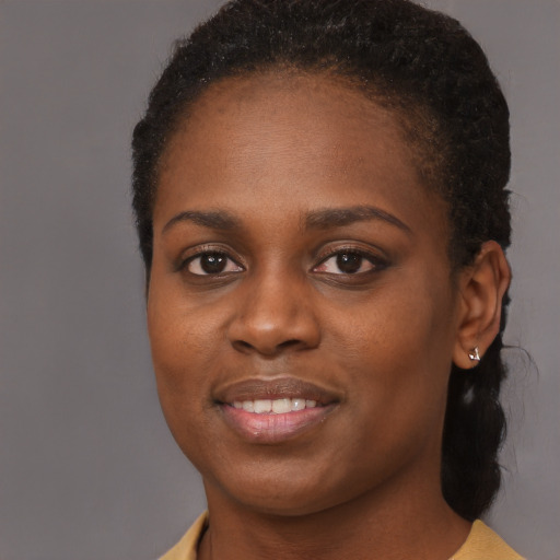Joyful black young-adult female with short  brown hair and brown eyes