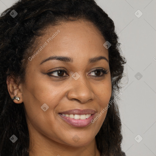 Joyful black young-adult female with long  brown hair and brown eyes