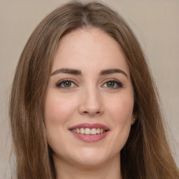 Joyful white young-adult female with long  brown hair and green eyes