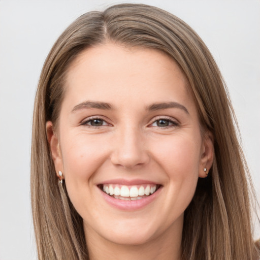 Joyful white young-adult female with long  brown hair and grey eyes