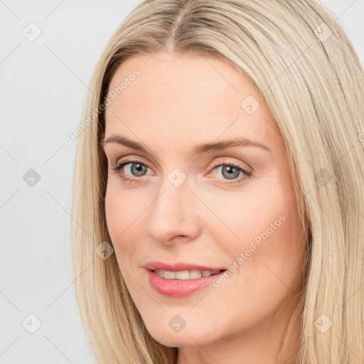 Joyful white young-adult female with long  brown hair and blue eyes