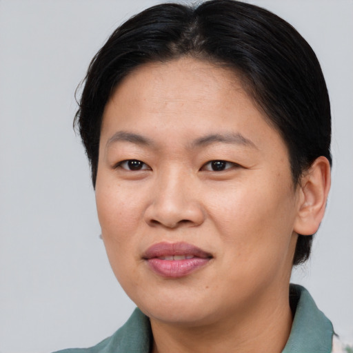 Joyful asian adult female with short  brown hair and brown eyes