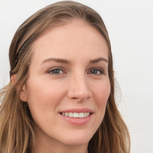 Joyful white young-adult female with long  brown hair and blue eyes