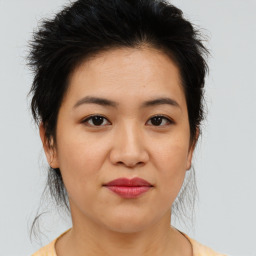 Joyful asian young-adult female with medium  brown hair and brown eyes