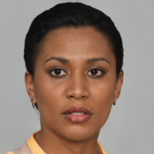 Joyful black young-adult female with short  brown hair and brown eyes