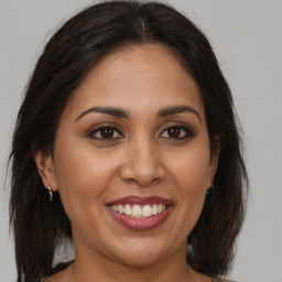 Joyful white young-adult female with medium  brown hair and brown eyes