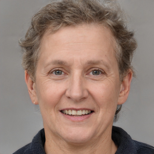 Joyful white middle-aged female with medium  brown hair and grey eyes