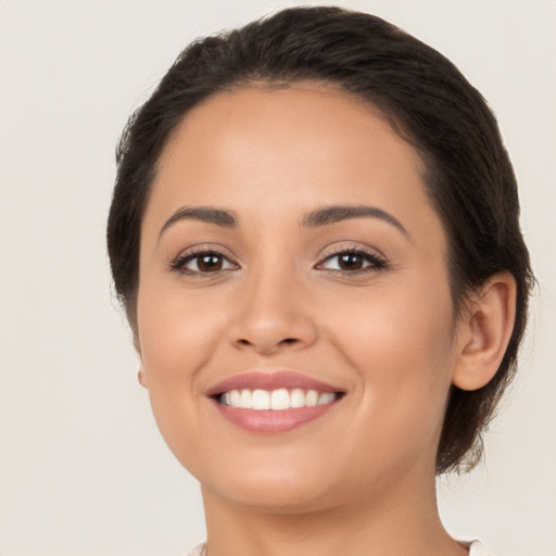 Joyful white young-adult female with long  brown hair and brown eyes