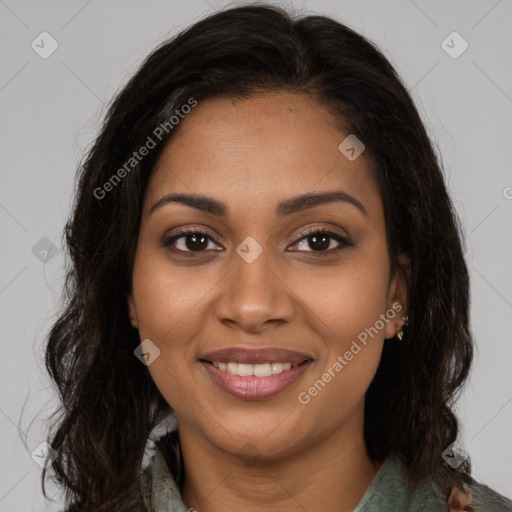 Joyful black young-adult female with long  brown hair and brown eyes