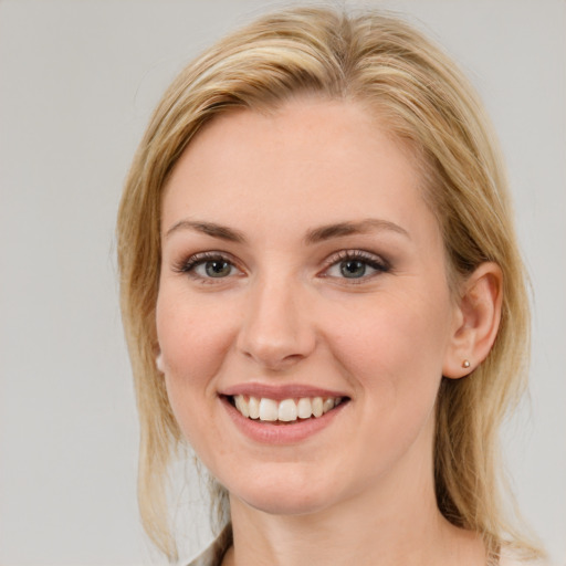 Joyful white young-adult female with medium  brown hair and blue eyes