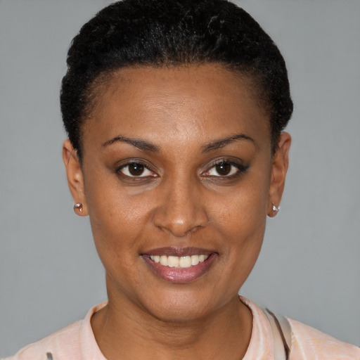 Joyful black young-adult female with short  brown hair and brown eyes