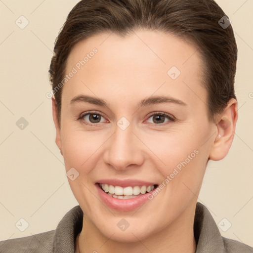 Joyful white young-adult female with short  brown hair and brown eyes