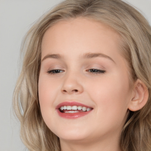 Joyful white child female with long  brown hair and brown eyes