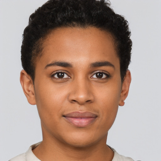 Joyful black young-adult male with short  brown hair and brown eyes