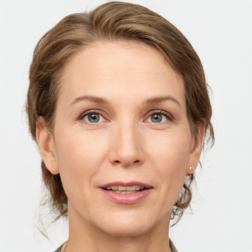 Joyful white adult female with medium  brown hair and grey eyes