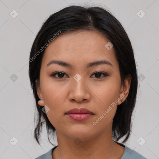 Joyful asian young-adult female with medium  black hair and brown eyes