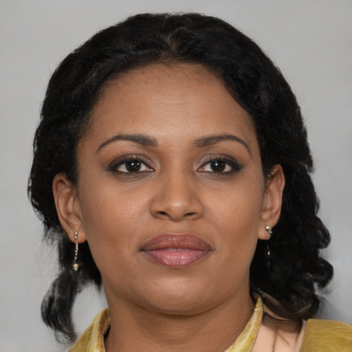 Joyful black young-adult female with medium  brown hair and brown eyes