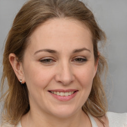 Joyful white adult female with medium  brown hair and brown eyes