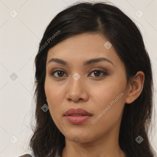 Joyful latino young-adult female with long  brown hair and brown eyes