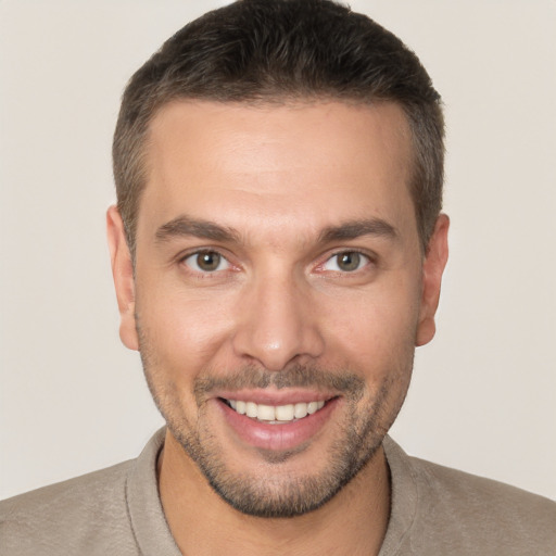 Joyful white young-adult male with short  brown hair and brown eyes