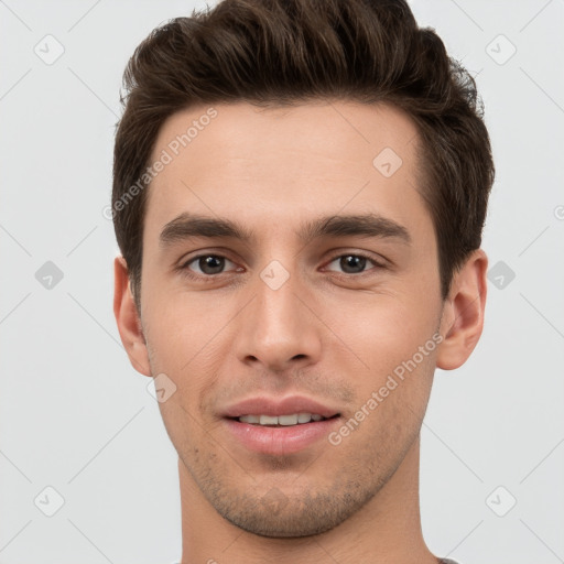 Joyful white young-adult male with short  brown hair and grey eyes