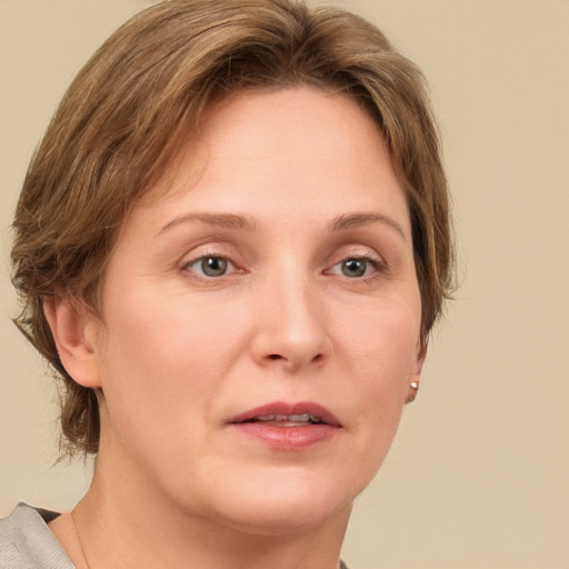 Joyful white adult female with medium  brown hair and grey eyes