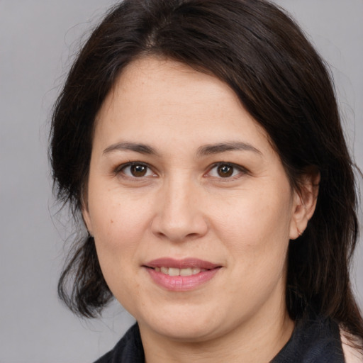 Joyful white adult female with medium  brown hair and brown eyes