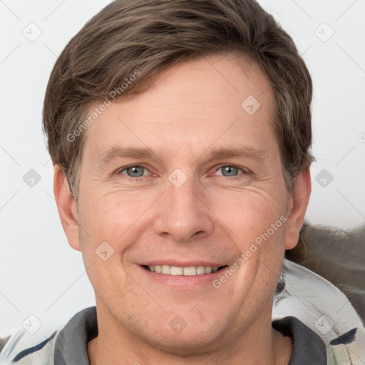 Joyful white adult male with short  brown hair and grey eyes