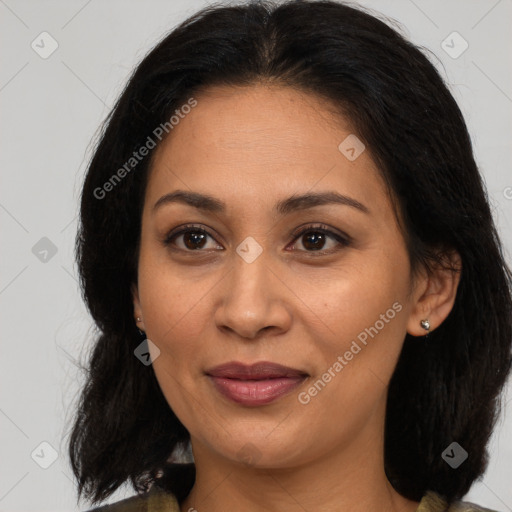 Joyful latino adult female with medium  brown hair and brown eyes