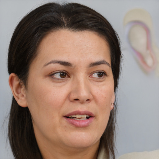 Joyful white adult female with medium  brown hair and brown eyes