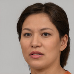 Joyful white adult female with medium  brown hair and brown eyes