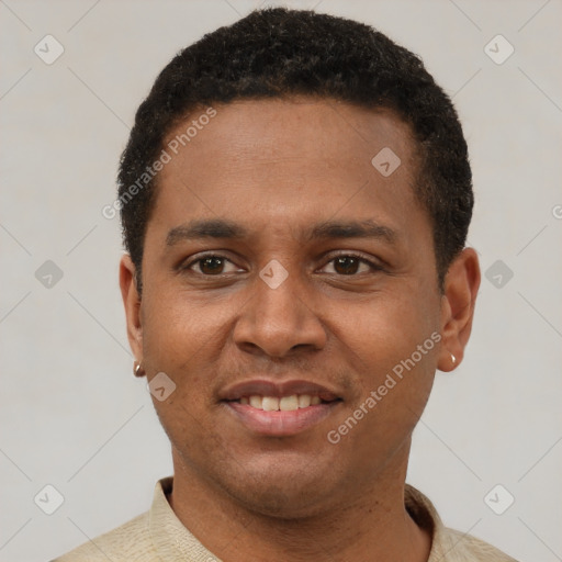 Joyful latino young-adult male with short  black hair and brown eyes