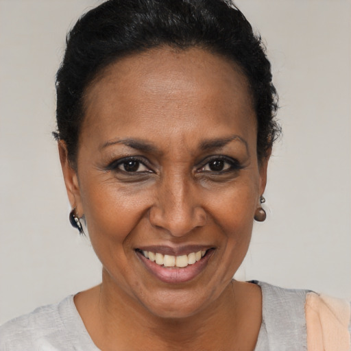 Joyful black adult female with short  brown hair and brown eyes