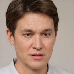 Joyful white adult male with short  brown hair and grey eyes