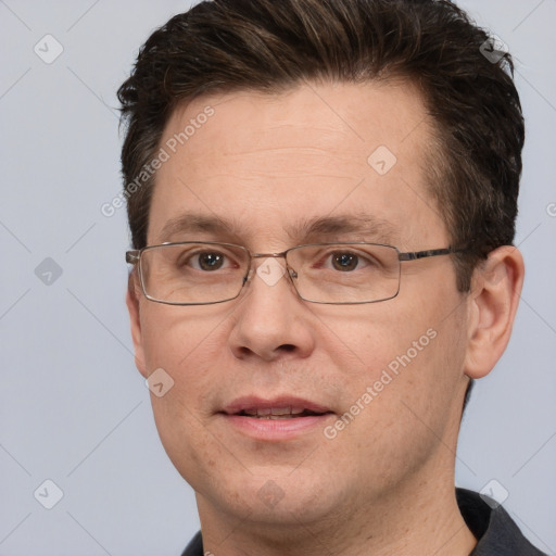 Joyful white adult male with short  brown hair and brown eyes