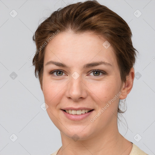 Joyful white young-adult female with short  brown hair and grey eyes