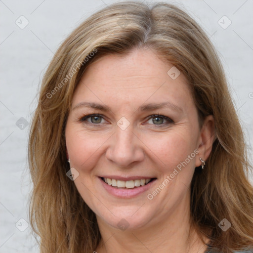 Joyful white adult female with long  brown hair and brown eyes