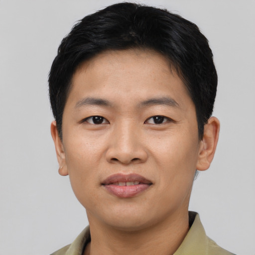 Joyful asian young-adult male with short  brown hair and brown eyes
