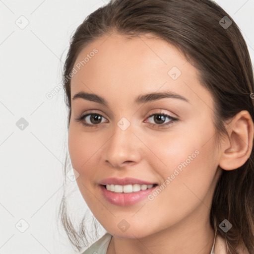 Joyful white young-adult female with long  brown hair and brown eyes